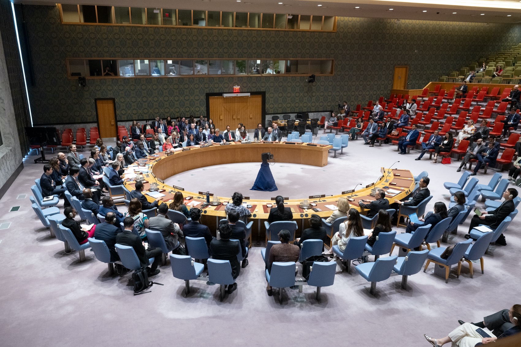 Wide view of security council chambers with meeting in session.