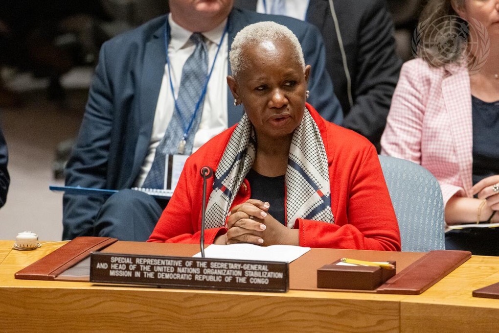 Woman speaking into a microphone.