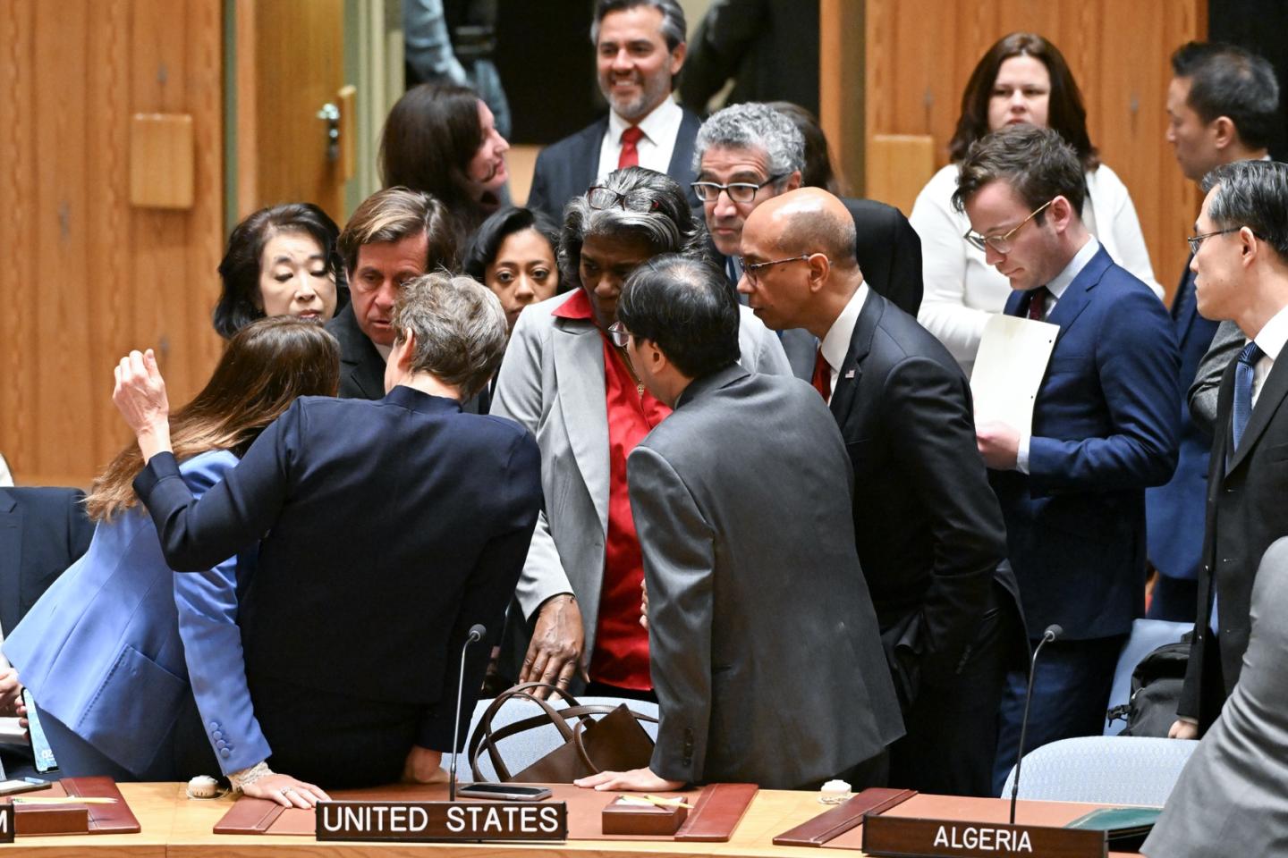 Group of people standing in a circle in discussion.