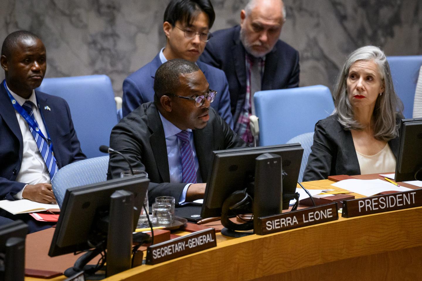 Michael Imran Kanu (center), Permanent Representative of Sierra Leone to the United Nations and President of the Security Council for the month of August, chairs the Security Council meeting on threats to international peace and security