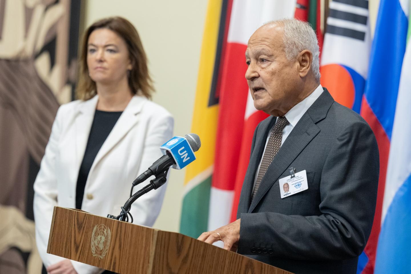 Man speaking into microphone at podium.
