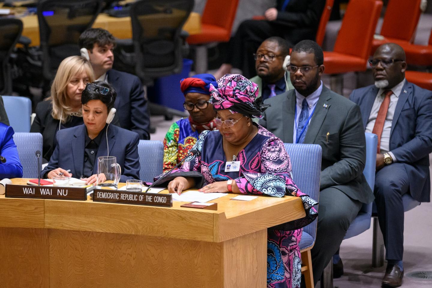 Women seated behind table during meeting.